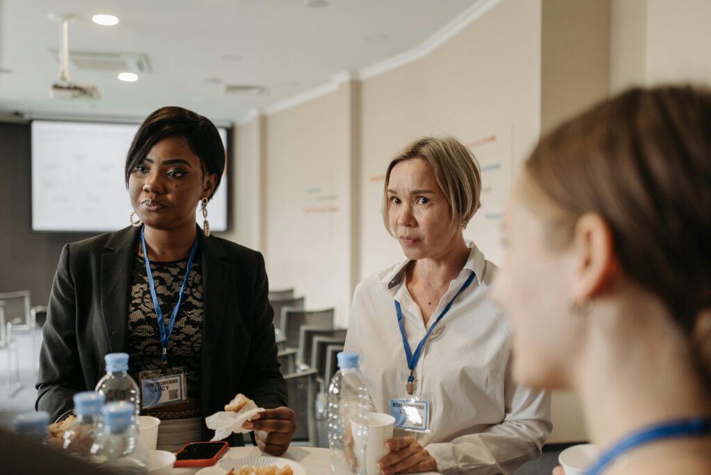 Business professionals networking during a break at a conference, engaging and discussing ideas.